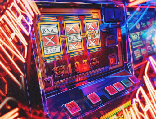 A vibrant scene featuring a classic slot machine with bright neon lights surrounding it. The slot machine displays symbols like 'Bar' and '7' and is set in a lively arcade environment. Reflections and colorful lighting add a sense of excitement and motion.